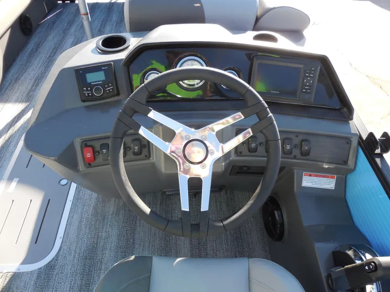 Slide: The Image of 2025 Bennington 22 SSB boat dashboard with steering wheel and control panel. - 8