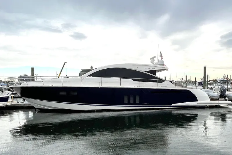 The Image of 2015 Fairline Targa 62 GT yacht docked at marina under cloudy sky. - 0
