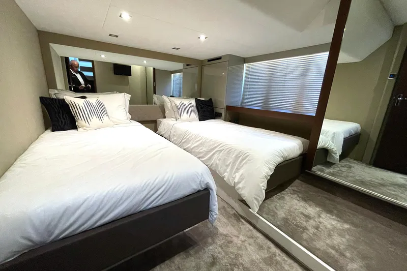 Slide: The Image of Luxurious twin bedroom in 2015 Fairline Targa 62 GT yacht, featuring modern decor and plush bedding. - 10