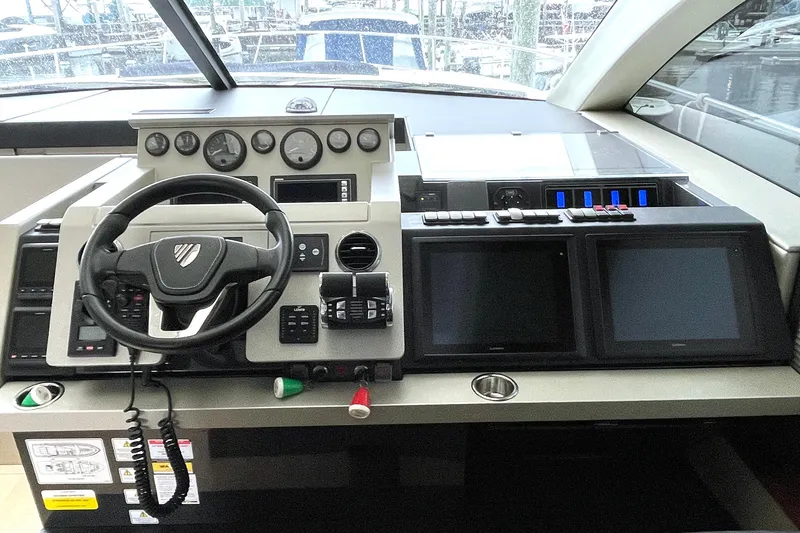 Slide: The Image of 2015 Fairline Targa 62 GT helm with steering wheel and navigation screens. - 16