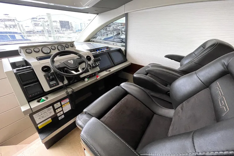 Slide: The Image of Luxury helm of 2015 Fairline Targa 62 GT yacht with leather seating and modern controls. - 18