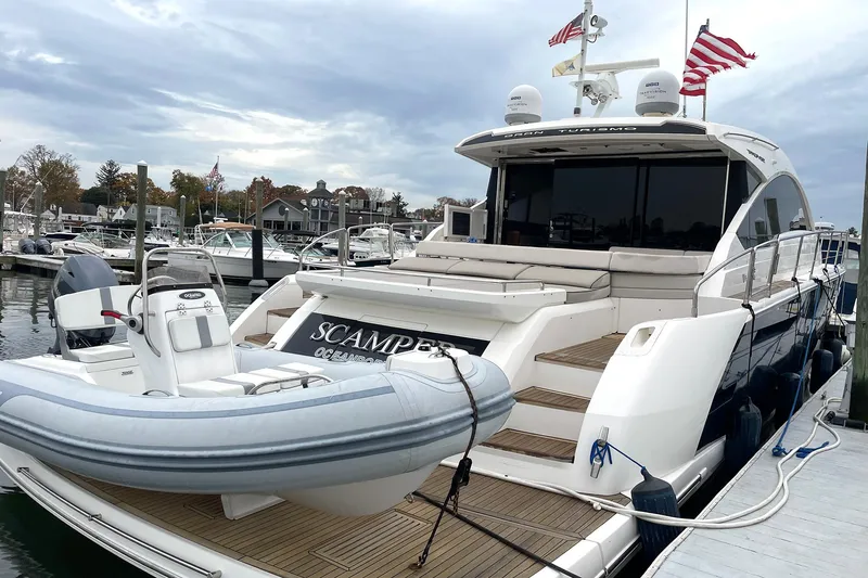 Slide: The Image of 2015 Fairline Targa 62 GT yacht docked with inflatable boat on deck. - 2