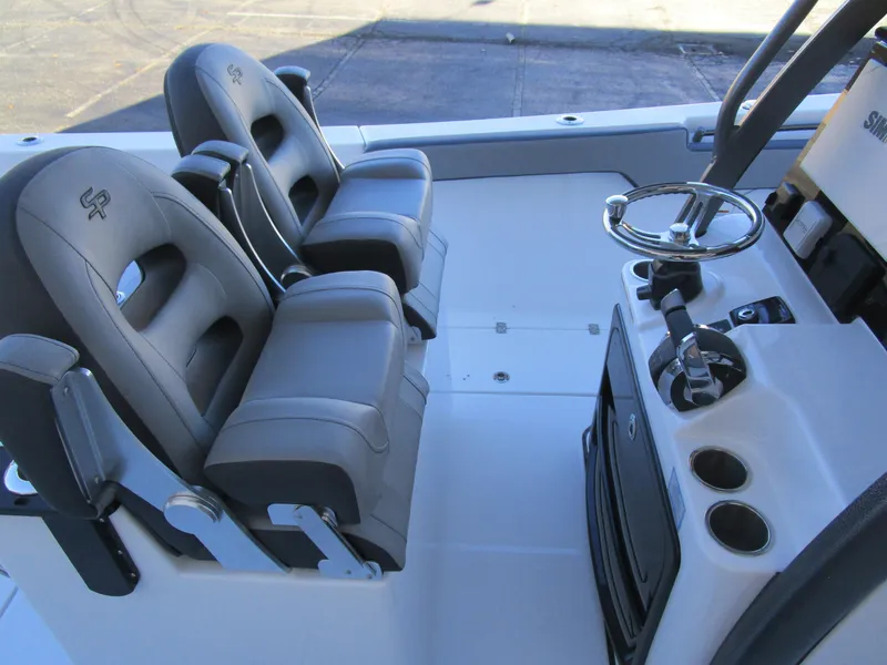 Slide: The Image of 2025 Sea Pro 292 Offshore boat cockpit with dual seats and steering console. - 17