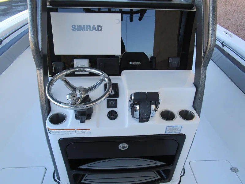 Slide: The Image of 2025 Sea Pro 292 Offshore helm with Simrad display and controls. - 18