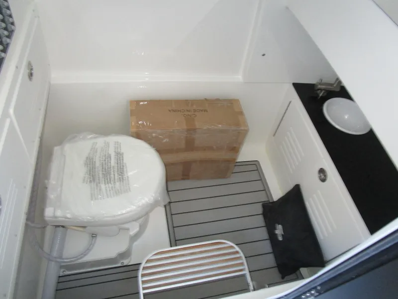 Slide: The Image of 2025 Sea Pro 292 Offshore boat interior with toilet and storage area. - 33