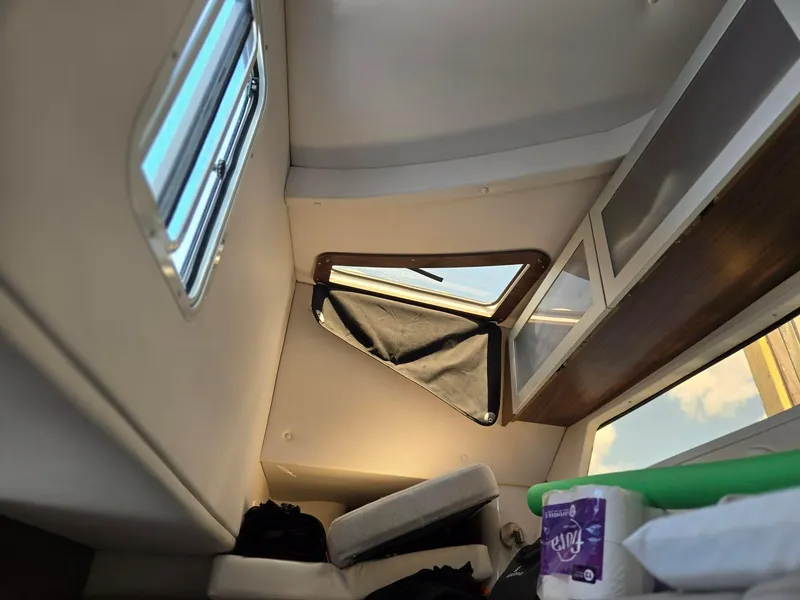 Slide: The Image of Interior cabin of 2019 Four Winns H350 boat with window and storage. - 14
