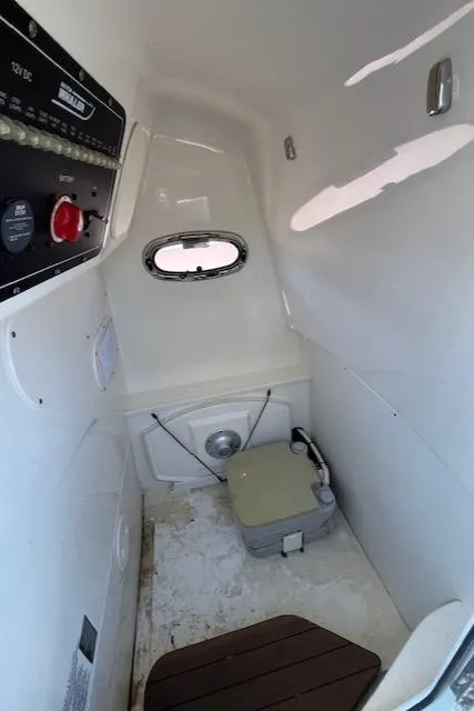 Slide: The Image of Interior of 2014 Boston Whaler 270 Dauntless boat with compact marine toilet. - 24