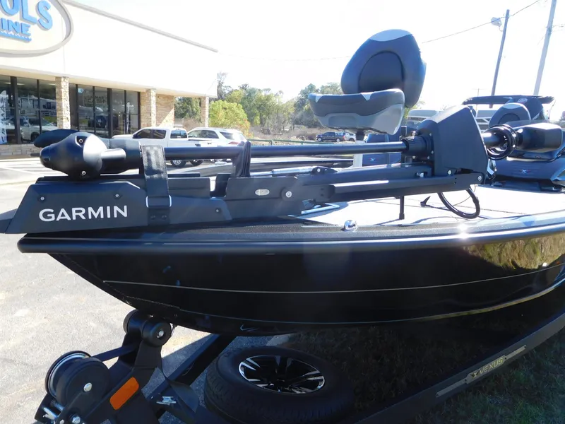 Slide: The Image of 2025 Vexus AVX 1985s boat with Garmin equipment, parked outside a store. - 7