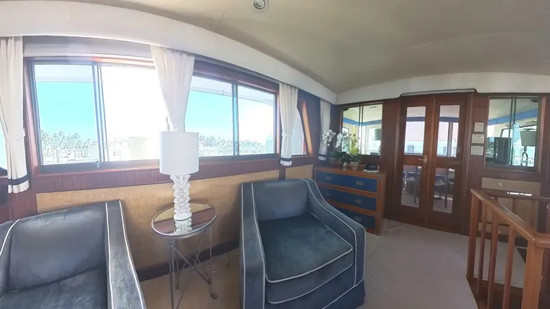 Slide: The Image of Interior of 1982 Hatteras 65 LRC yacht with plush seating and large windows. - 11