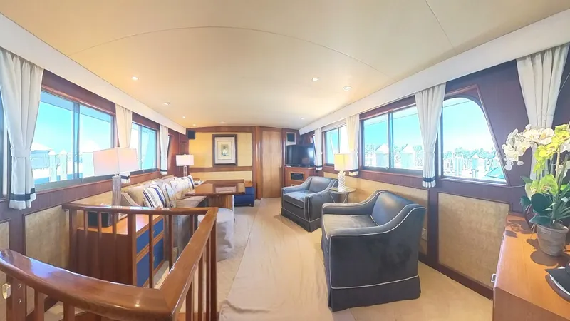 Slide: The Image of Luxurious interior of 1982 Hatteras 65 LRC yacht with elegant seating and large windows. - 13