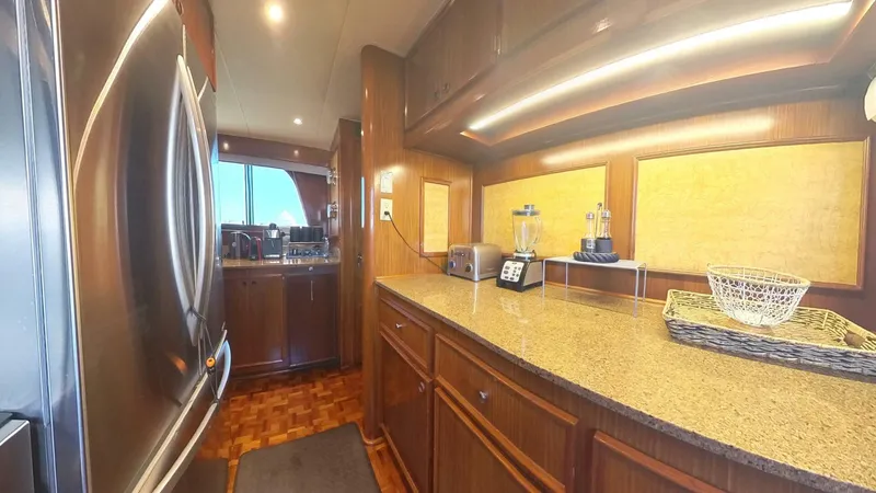 Slide: The Image of Luxurious kitchen interior of 1982 Hatteras 65 LRC yacht with modern appliances. - 16