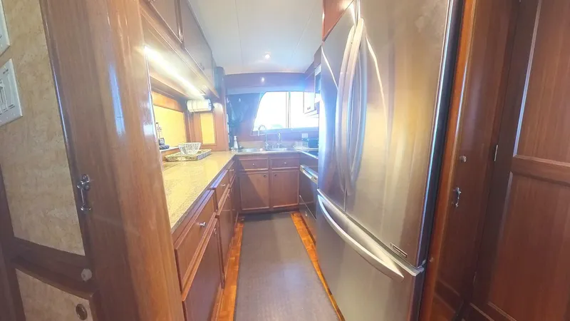 Slide: The Image of Luxurious kitchen interior of 1982 Hatteras 65 LRC yacht with modern appliances. - 18
