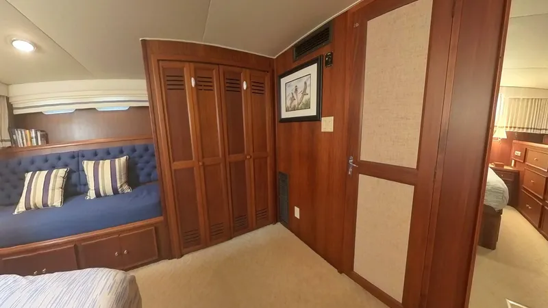 Slide: The Image of Interior of 1982 Hatteras 65 LRC yacht with wood paneling and cozy seating area. - 31