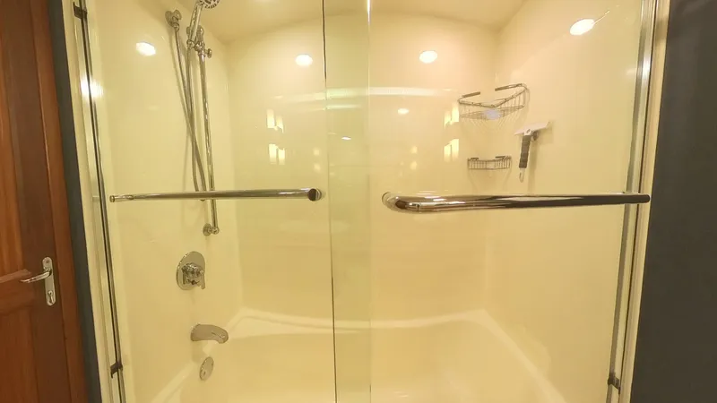 Slide: The Image of Luxurious shower in 1982 Hatteras 65 LRC yacht with glass doors and chrome fixtures. - 34