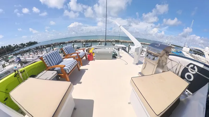 Slide: The Image of Spacious deck of 1982 Hatteras 65 LRC yacht with seating and ocean view. - 44