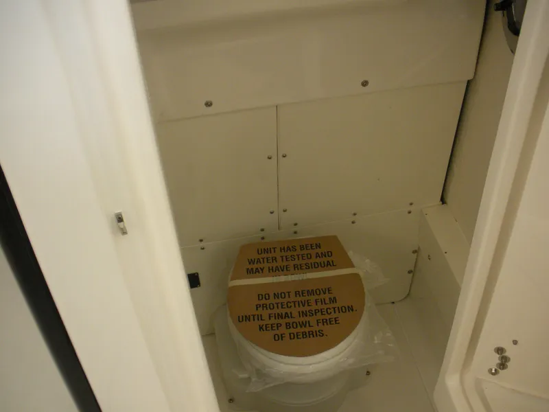 Slide: The Image of 2025 Robalo R250 Center Console boat interior with protective toilet cover. - 11