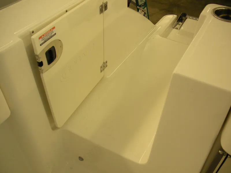 Slide: The Image of 2025 Robalo R250 Center Console boat interior detail, featuring storage compartment and seating area. - 22