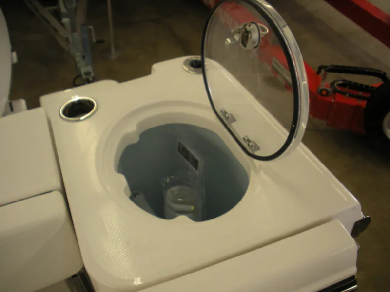 Slide: The Image of 2025 Robalo R250 Center Console livewell with open lid, showcasing interior features. - 23