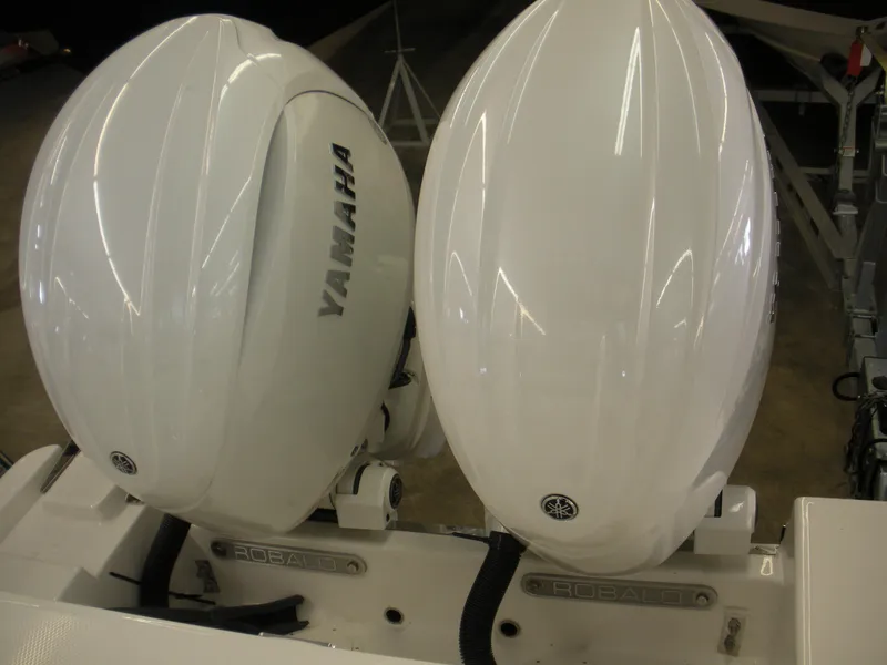 Slide: The Image of Twin Yamaha outboard engines on a 2025 Robalo R250 Center Console boat. - 24