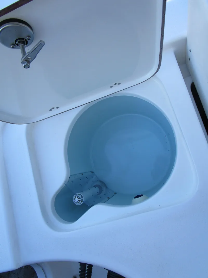 Slide: The Image of 2025 Sea Pro 230 Bay livewell with open lid, showcasing interior design. - 10