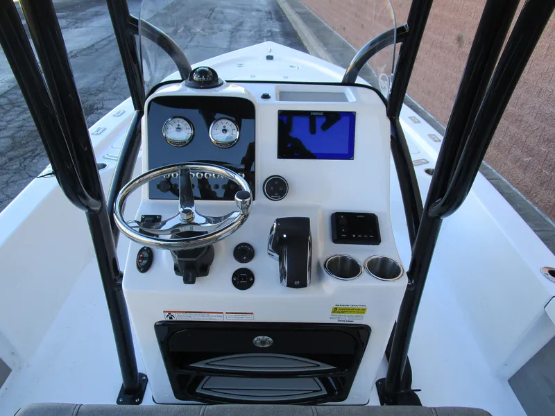 Slide: The Image of 2025 Sea Pro 230 Bay boat console with steering wheel and navigation display. - 15