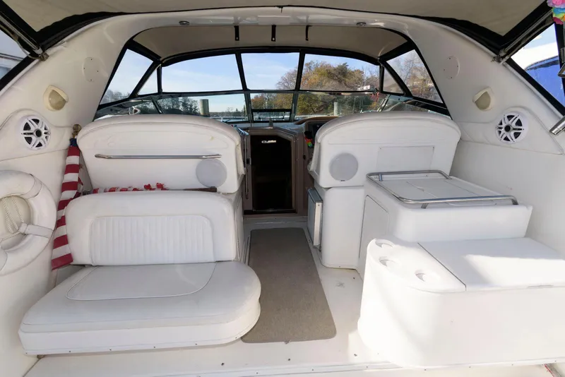 Slide: The Image of Interior of 2001 Sea Ray 340 Amberjack boat with white seating and spacious layout. - 10