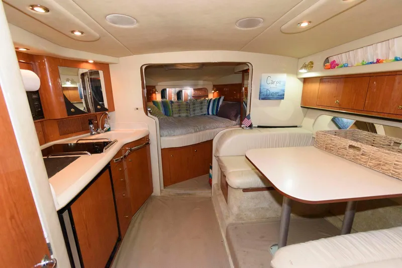 Slide: The Image of Interior of 2001 Sea Ray 340 Amberjack boat with kitchen and dining area. - 13