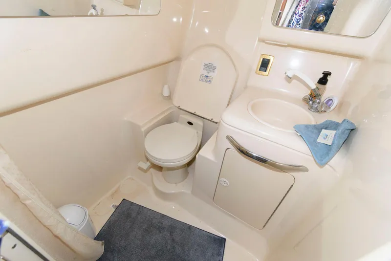 Slide: The Image of Compact bathroom in 2001 Sea Ray 340 Amberjack boat, featuring toilet and sink. - 17