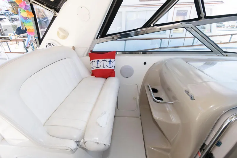 Slide: The Image of Interior of 2001 Sea Ray 340 Amberjack with white seating and nautical-themed pillow. - 6