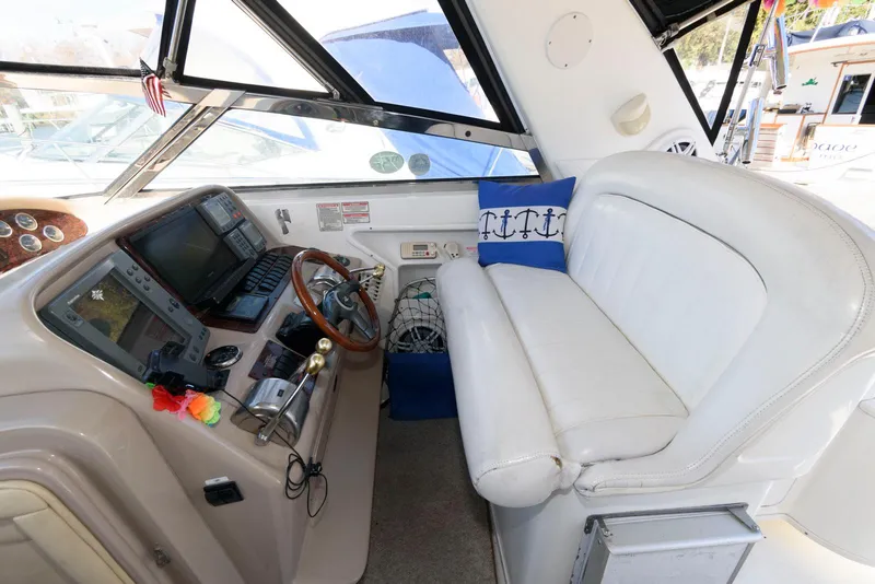 Slide: The Image of 2001 Sea Ray 340 Amberjack helm with steering wheel, navigation equipment, and white seating. - 7