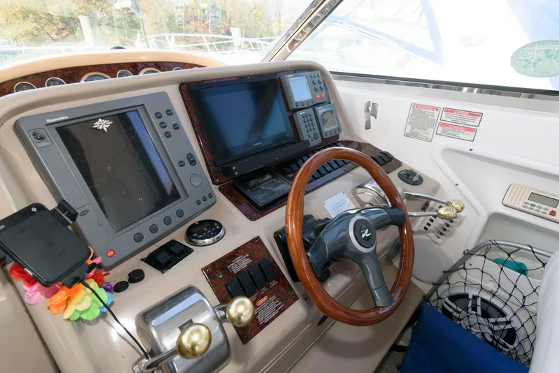 Slide: The Image of 2001 Sea Ray 340 Amberjack helm with navigation equipment and steering wheel. - 8