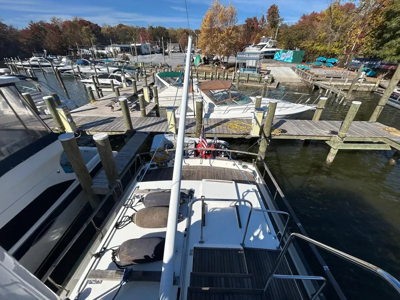 Slide: The Image of 1986 Grand Banks 42 Classic yacht docked at a marina with autumn foliage. - 10