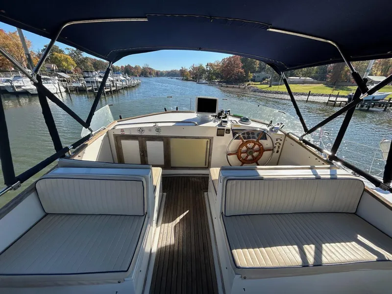 Slide: The Image of 1986 Grand Banks 42 Classic yacht interior with helm, seating, and waterway view. - 11