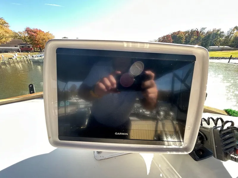 Slide: The Image of Garmin navigation display on 1986 Grand Banks 42 Classic boat, docked by a scenic waterfront. - 14