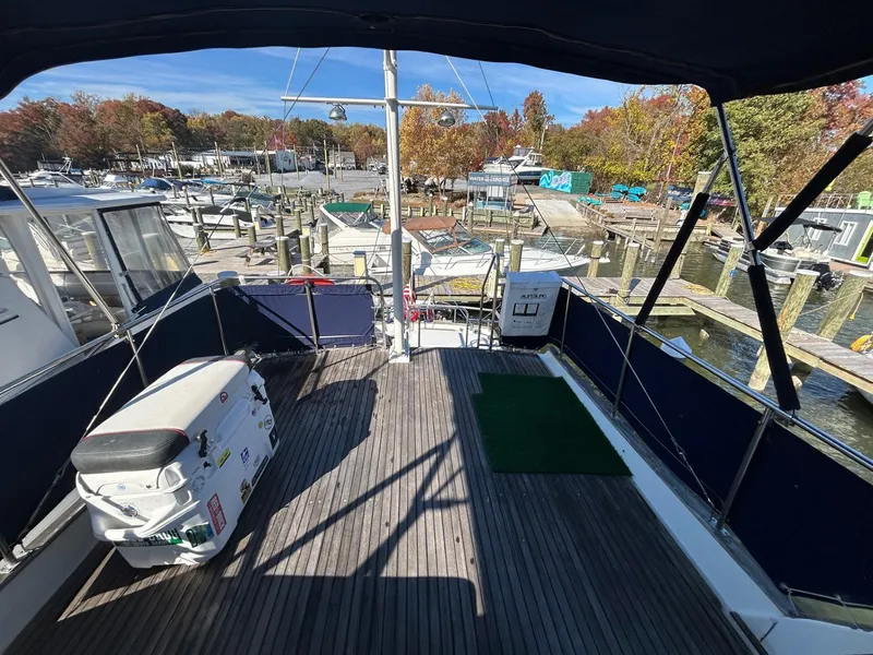 Slide: The Image of 1986 Grand Banks 42 Classic yacht docked at marina, spacious deck view. - 18