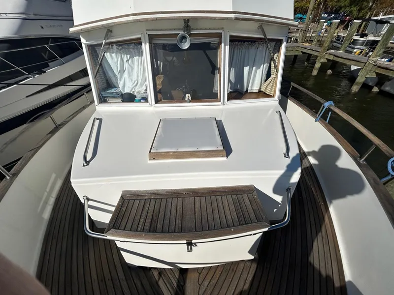 Slide: The Image of 1986 Grand Banks 42 Classic yacht deck with wooden details and windows. - 19