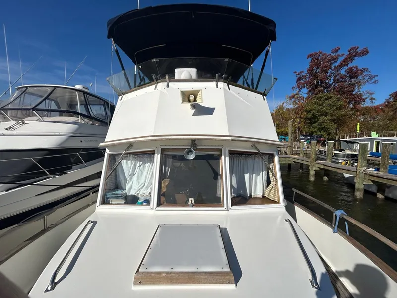Slide: The Image of 1986 Grand Banks 42 Classic yacht docked at marina under clear blue sky. - 20