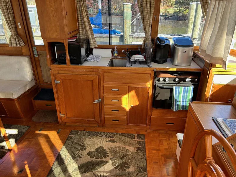 Slide: The Image of Interior of 1986 Grand Banks 42 Classic yacht kitchen with wooden cabinetry and appliances. - 23