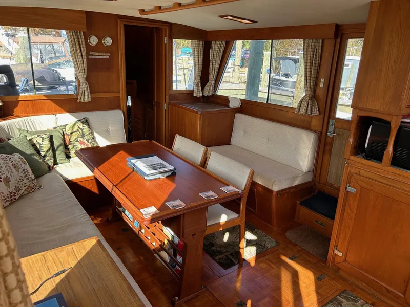 Slide: The Image of Interior of 1986 Grand Banks 42 Classic yacht with wooden furnishings and cozy seating area. - 24
