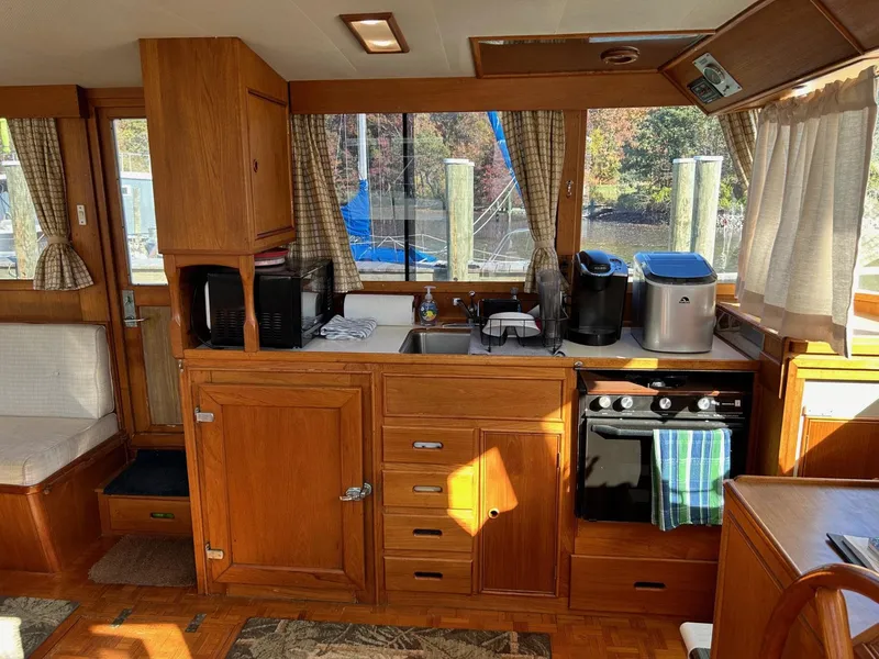 Slide: The Image of Interior of 1986 Grand Banks 42 Classic yacht with wooden cabinetry and kitchen appliances. - 25