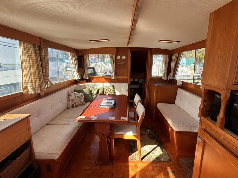 Slide: The Image of Interior of 1986 Grand Banks 42 Classic yacht with cozy seating and wooden furnishings. - 26