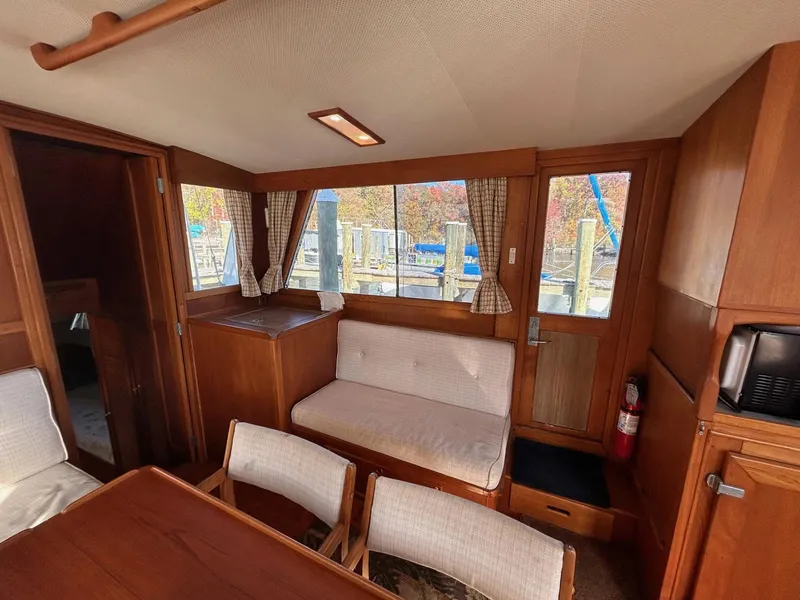 Slide: The Image of Interior of 1986 Grand Banks 42 Classic yacht with wood finish and seating area. - 28