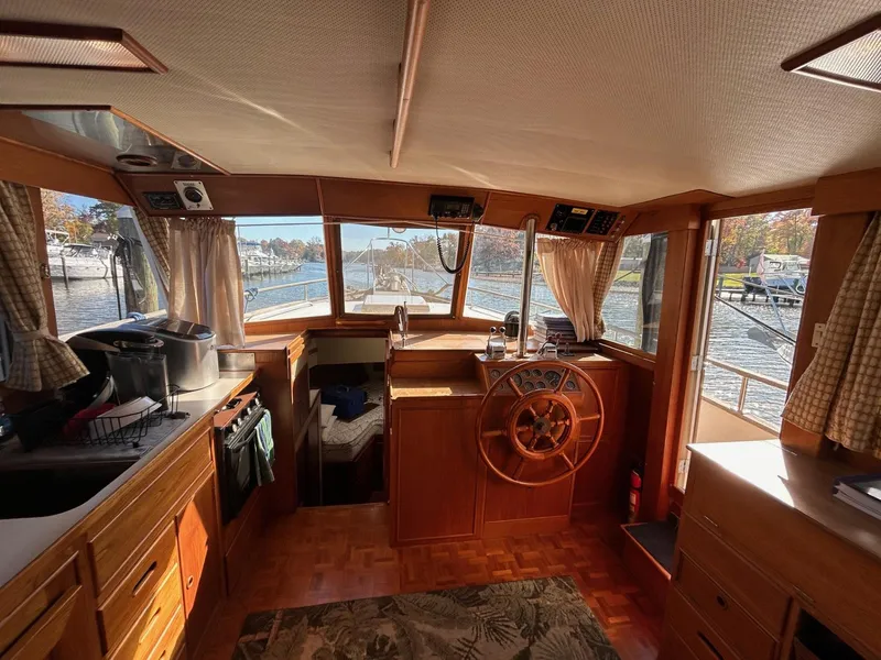 Slide: The Image of Interior of 1986 Grand Banks 42 Classic yacht with wooden helm and panoramic windows. - 29