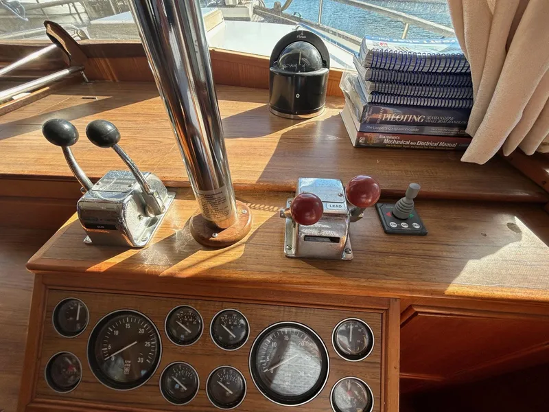 Slide: The Image of Grand Banks 42 Classic 1986 helm with controls, gauges, and navigation equipment. - 32