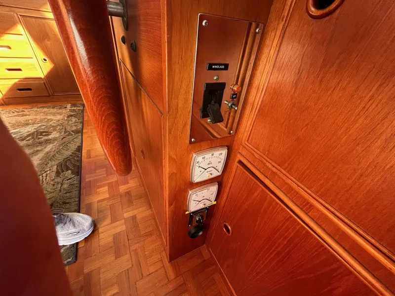 Slide: The Image of 1986 Grand Banks 42 Classic interior with wooden paneling and control gauges. - 33