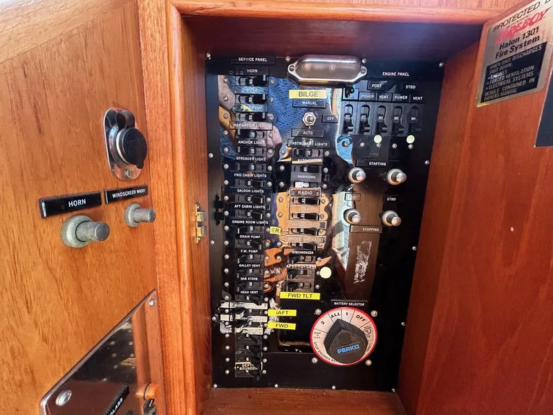 Slide: The Image of Electrical panel of a 1986 Grand Banks 42 Classic boat, featuring switches and gauges. - 34