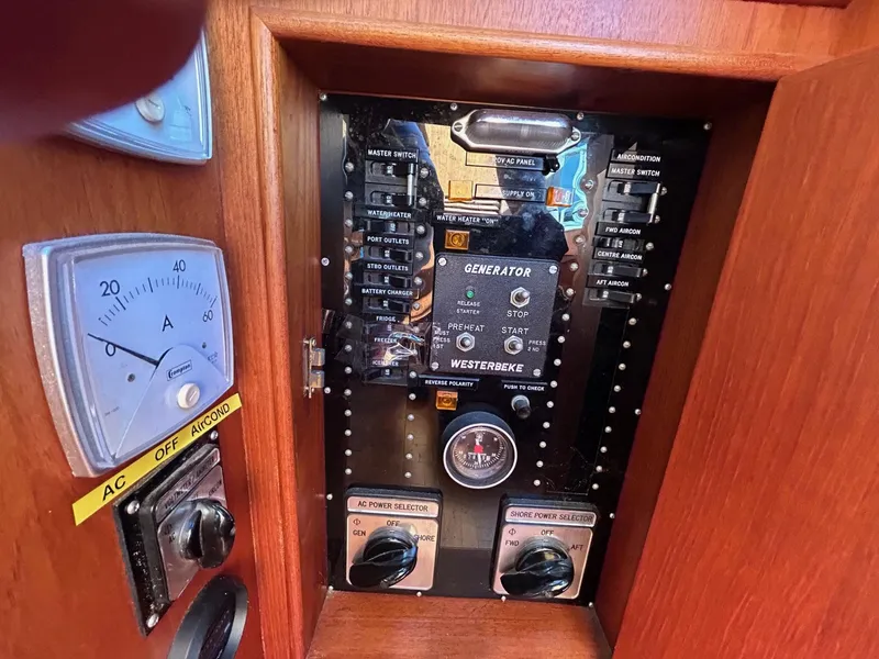 Slide: The Image of Control panel of 1986 Grand Banks 42 Classic boat with generator and AC settings. - 35