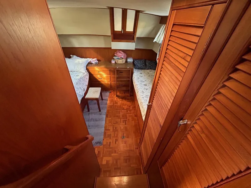 Slide: The Image of 1986 Grand Banks 42 Classic cabin interior with twin beds and wooden furnishings. - 36
