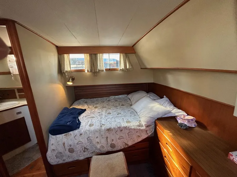 Slide: The Image of Cozy bedroom in 1986 Grand Banks 42 Classic yacht with wooden furnishings and natural light. - 38