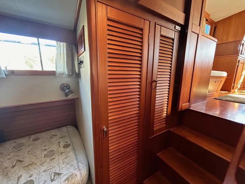 Slide: The Image of 1986 Grand Banks 42 Classic interior with wooden cabinetry and cozy sleeping area. - 40
